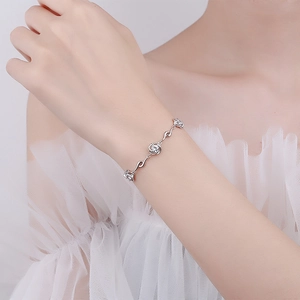 S925 sterling silver chain bracelet featuring three crystal clover flower pendants on wrist