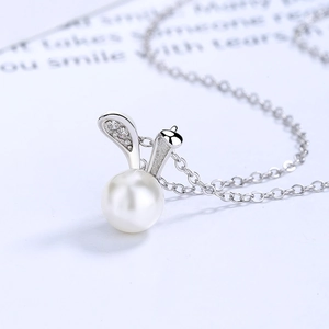 Elegant 925 silver rabbit ear pearl necklace with shimmering zircon stones on white background