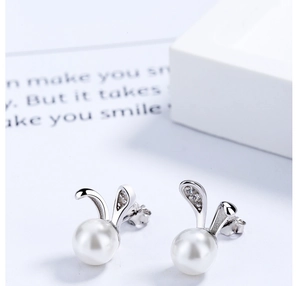 Detail of silver bunny pearl earrings featuring sparkling crystal-set ears and butterfly backs