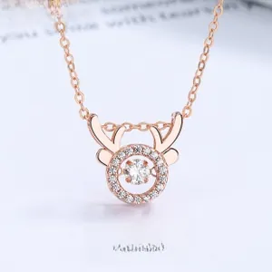 Macro detail of dancing reindeer antler pendant necklace in 18k rose gold plating