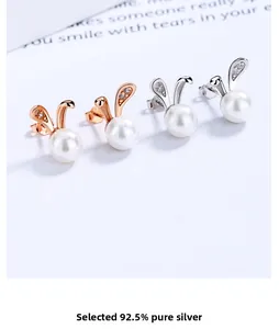 Detail of 925 sterling silver bunny pearl earrings with sparkling cubic zirconia accents