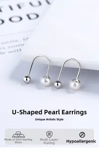 Macro shot of U-shaped S925 sterling silver earrings with freshwater pearl detail