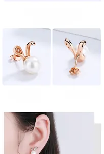 Close-up of rabbit pearl earrings in rose gold with zircon inlay and butterfly backings