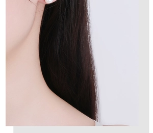Close-up of minimalist white pearl stud earring worn on earlobe with elegant pearly luster