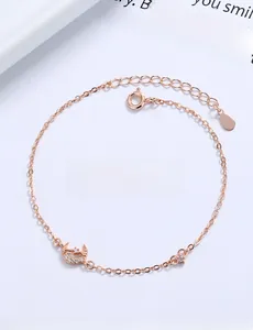 Detail view of rose gold star and moon bracelet charms with sparkling zirconia stones