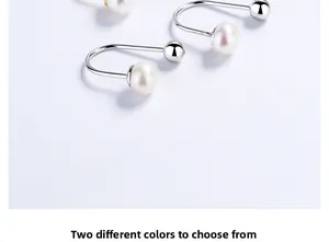 Macro view of U-shaped S925 sterling silver earrings with white freshwater pearl detail