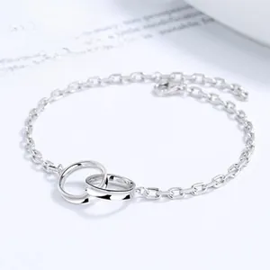 Detailed close-up of 925 sterling silver Mobius loop bracelet with polished interlocking rings