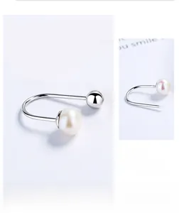 Detailed view of S925 silver U-shaped pearl earring with secure screw-on closure detail