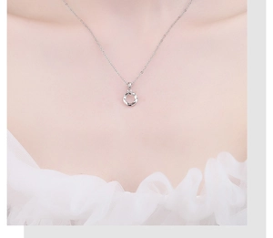 Close-up of a 925 sterling silver Mobius twist pendant necklace on a female model