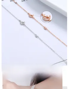 Detail of moon and star charms with pavé set white crystals on silver and rose gold chains
