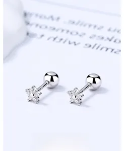 Macro shot of 925 sterling silver star stud earrings with zircon inlay and screw ball back