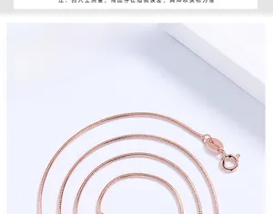 Detail of rose gold snake chain necklace with spring ring clasp on white background
