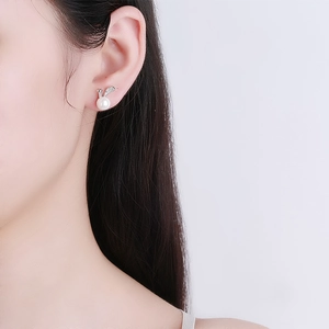 Elegant 925 sterling silver bunny pearl stud earrings shown on a model's ear