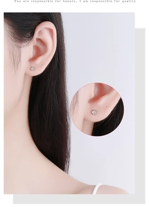 Close-up of sparkling 925 silver flower stud earring with cubic zirconia inlay on ear
