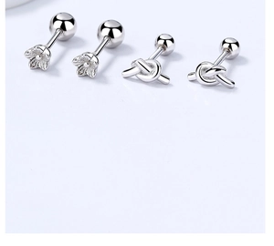 Macro detail of S925 sterling silver flower and knot screw-back stud earrings