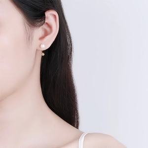 Minimalist S925 silver U-shaped freshwater pearl earrings on model with golden accents