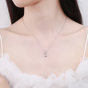 Elegant 925 sterling silver Mobius loop pendant necklace on model collarbone