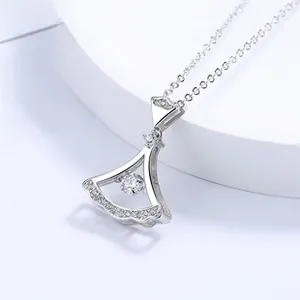 Macro shot of silver rotating fan-shaped pendant with crystal pavé and center stone