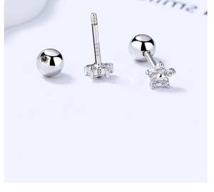 Detail of 925 sterling silver star stud earrings with screw ball back and sparkling zircons