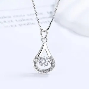 Detail of water drop pendant with dancing stone centerpiece on silver box chain