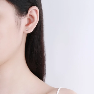 Minimalist 925 sterling silver star stud earring with sparkling cubic zirconia on model