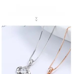 Macro shot of silver and rose gold S925 sterling silver clover necklaces with zircons