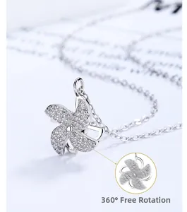 Detail of 925 silver windmill necklace with rotating pendant and white zircon inlay