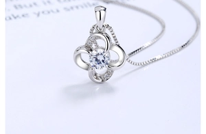 Macro view of s925 silver clover necklace pendant with zircon and box chain details