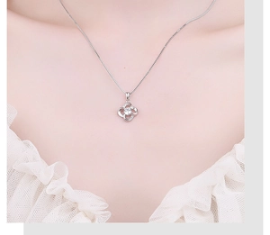 Close-up of s925 silver four-leaf clover necklace with sparkling cubic zirconia stones