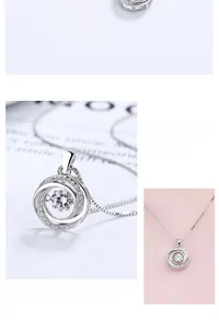 Macro view of interlocking silver pendant with a central sparkling gemstone and accents