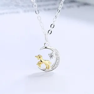 Detail of S925 silver crescent moon pendant with gold unicorn and sparkling crystals