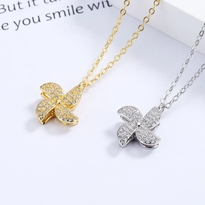 Double-layer rotating windmill necklace in gold and silver finish with zirconia pavé