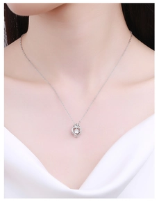 Detail van s925 zilveren hartketting met een fonkelende steen op de nek