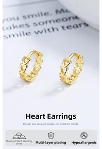 Detail of gold hollow heart hoop earrings made of s925 sterling silver with plating