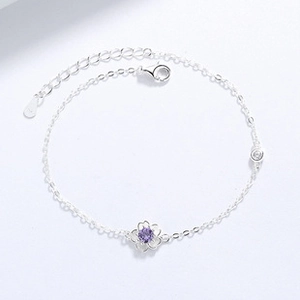 Macro shot of 925 silver flower bracelet with purple zircon and lobster clasp detail