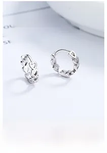 Close-up of S925 sterling silver hollow heart-shaped hoop earrings for women