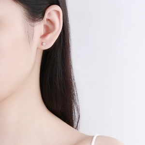 Minimalist 925 sterling silver zircon stud earring in rose gold on model's ear