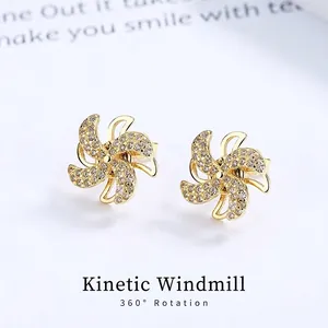 Rotating windmill stud earrings in gold with sparkling zircon stones in minimalist style