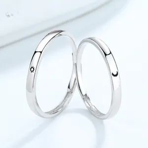 Close-up of S925 sterling silver sun and moon couple rings with minimalist thin band design