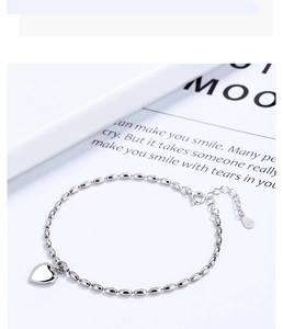 Detail of 925 sterling silver heart bracelet with beaded chain and lobster clasp