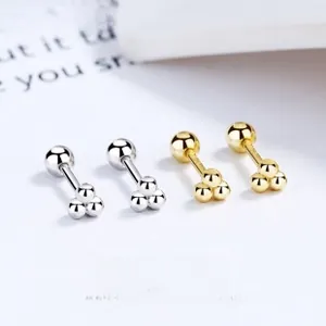Minimalist silver and gold ball screw back earrings on a clean white background