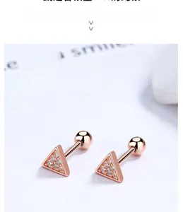Macro shot of rose gold triangle studs with pavé cubic zirconia and screw-back closure