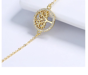 Detailed shot of Tree of Life bracelet featuring a gold hollow pendant and pavé zircons