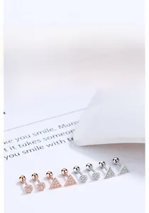 Close-up of 925 sterling silver geometric stud earrings with tiny pavé zircon stones
