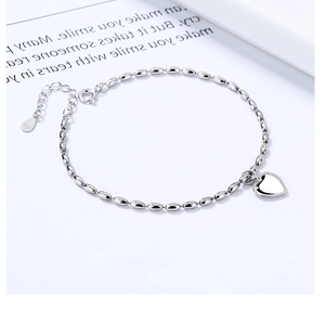 Macro detail of S925 sterling silver beaded bracelet showing the heart pendant and clasp