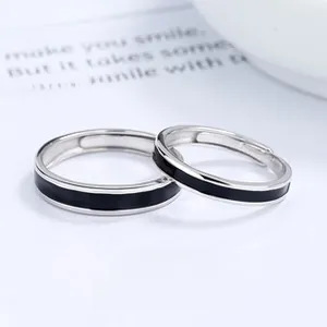 Detail of adjustable couple rings with silver finish and black enamel band inlay