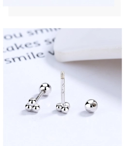 Detailed macro view of S925 sterling silver triple-bead screw back stud earrings