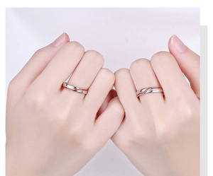 Detailed close-up of 925 sterling silver couple rings with elegant red enamel spiral lines