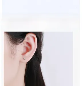 Close-up of minimalist S925 sterling silver three-point cluster stud earring on model