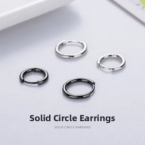 Detail of minimalist solid circle hoop earrings in polished silver and black finish